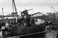Munro, Perry, Denton and Sheppeck on 12 pdr gun platform, HMS Queen of Thanet, April 1942
